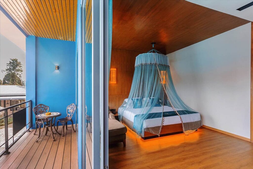 Deluxe King Room bed beside the private balcony