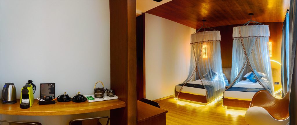 Mini bar and twin beds in the Deluxe Twin Room