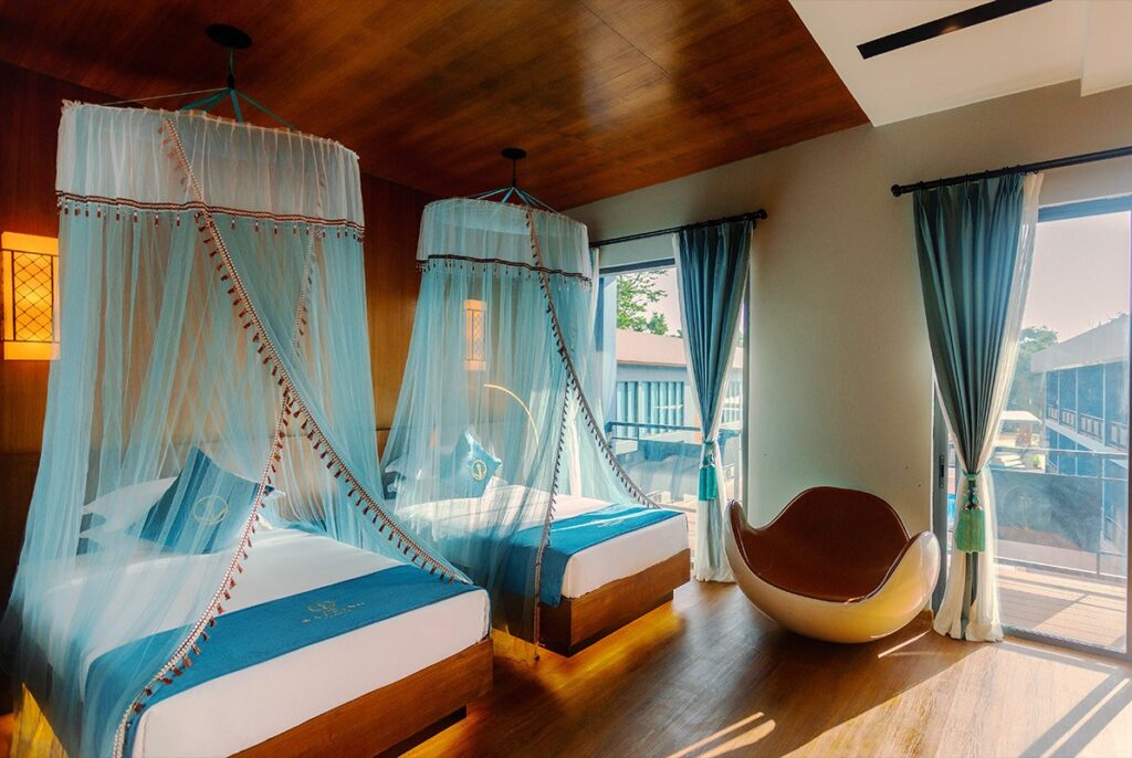 Twin beds and a ball chair by the window