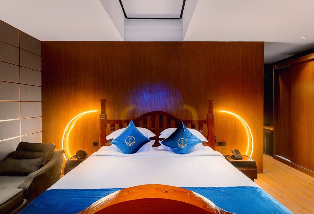 Luxury Duplex bedroom with a king-size bed and a warm teak wall